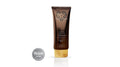 A brown squeeze tube of Avgerinos Coconut Dream Cream & Body Lotion with a gold cap, shown on a white background with a silver Vegan Silver badge overlay. Smells Summer! 