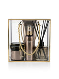 A luxury gift set in a clear acrylic box with a gold frame, containing avgerinos Perla body oil spray ,a matching Perla body scrub jar, and a reed diffuser by Gzen candles with gold rope handles. Perfect for gift in Cyprus buy online ship worldwide.