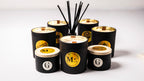 Set of black scented soy candles with wood wick and  gold labels by gzen candles on a white background are  hand poured in cyprus 