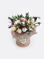 A dried flower arrangement in a round floral box with lace and burlap wrapping, photographed on a clean white background with scented soy wax  candle flowers