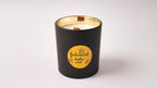 Black soy candle with a gold and black and scent of Johnson's Baby Powder label on a white background. A handmade soy candle with wood wick made in Cyprus and ship worldwide 