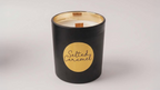 A black and gold  jar with soy candle with a gold label on a white background. Scent salted caramel

