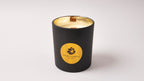 Luxury black candle with gold interior and logo of gzen on a white background. A soy wax candle with Eco-Friendly and hypoallergenic fragrance with wood wick handmade in Cyprus 