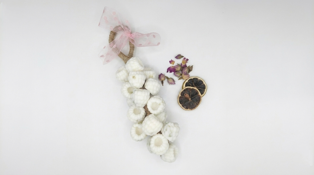 Decorative wreath with white berries, handmade soap on a robe on a white background