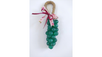 A decorative hanging ornament shaped like a bunch of green soap grapes with a natural jute loop at the top and a pink floral ribbon bow, shown on a plain white background. This is a natural handmade soap with eco friendly and hypolallergenis fragrance by Gzen candles . 