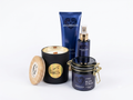 A collection of five Avgerinos self-care and bath products arranged on a white background, including a gzen scented soy candle with a wooden lid and wood wick, a body scrub jar, a starbody cream tube, and star body oil in spray bottle. Gzen gift set is perfect for gift and you can buy online. Base in Limassol, Cyprus ship worldwide.