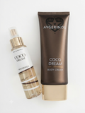 A bottle of Avgerinos Coco Dream Body & Hair Mist next to a tube of Avgerinos Coco Dream Body Cream, both in the 'Coco Dream' scent, arranged on a clean white background.