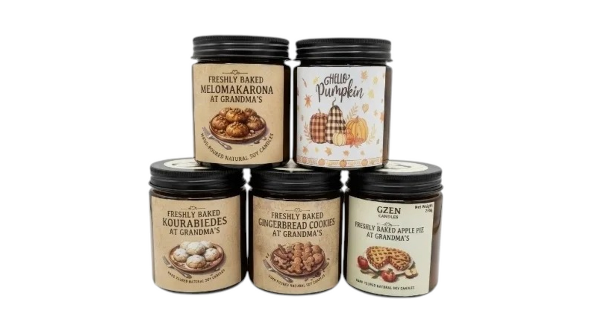 Five glass jars of gourmet baked goods arranged in a pyramid stack on a white background. The top row features two jars: 'Freshly Baked Melomakrona at Grandma's' and 'Ghen Pumpkin'.