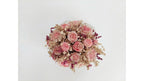 A dried flower bouquet featuring pink roses, pink gerbera daisies, and beige filler flowers, arranged in a round shape against a plain white background.