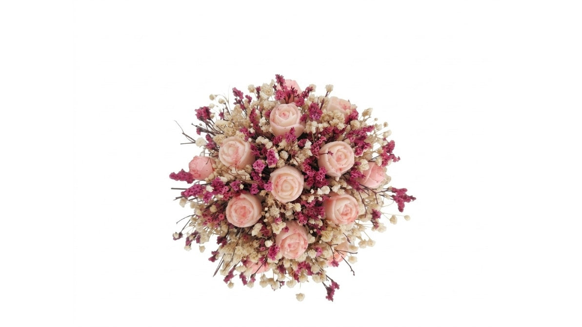 A dried floral arrangement featuring light pink roses, deep magenta baby's breath, and cream filler flowers, centered on a solid white background.