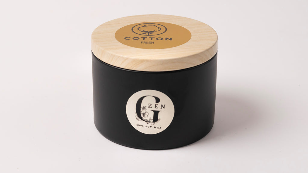 a scented soy candle handured in cyprus in a black metal tin with wood wick 