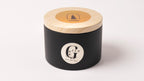 Black metal tin scented soy candle on a white background. Scent soft cashmere handpured in cyprus by gzen candles
