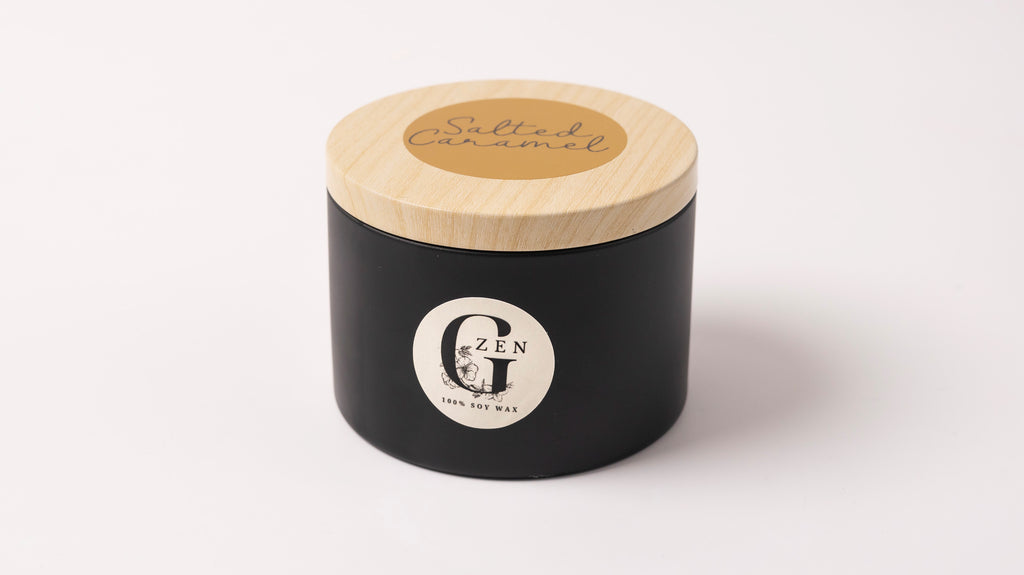 Black metal container with lid featuring a logo of gzen candles on a white background