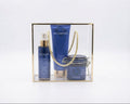 avgerinos cosmetics Star gift set for  in a clear acrylic box with a gold for woman e, containing a blue Star Oil bottle, a blue Star Body Wash tube, and a blue Star Body Butter jar with a gold rope handle, on a white background.