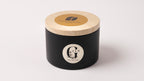 a scented soy candle handured in cyprus in a black metal tin with wood wick 