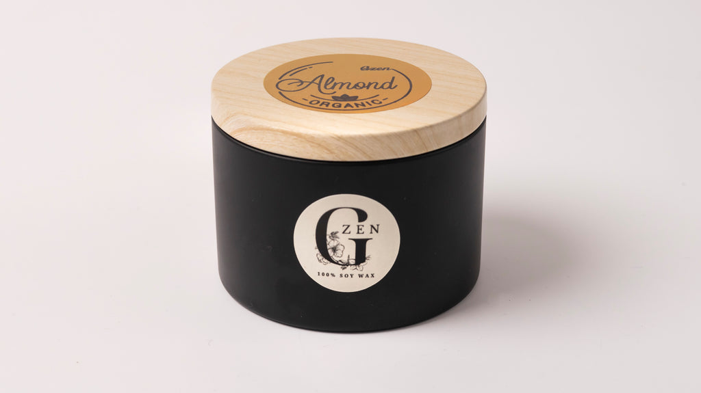 Black candle jar with wooden lid on a white background